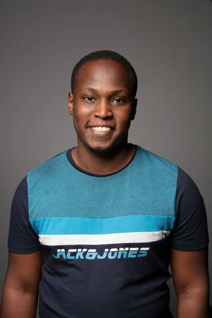 A smiling young black man in a t-shirt